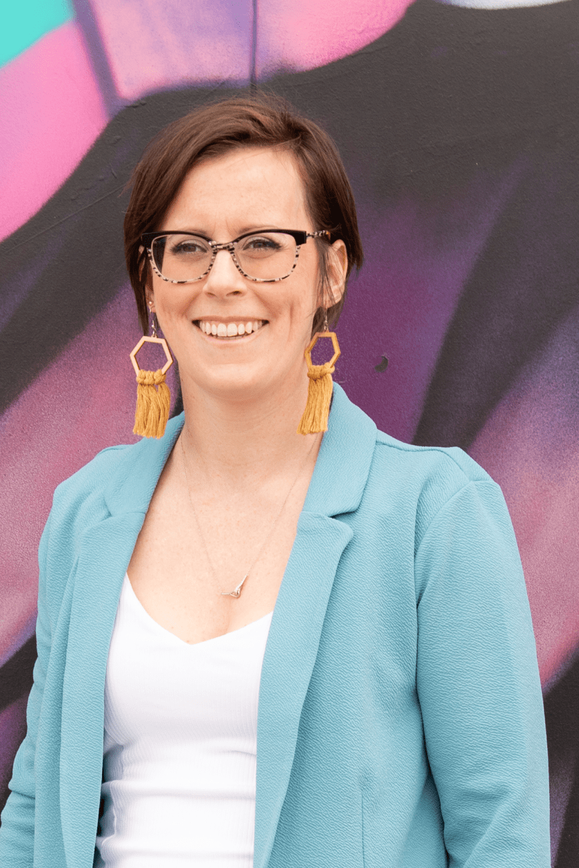 sarah mckenzie standing in front of graffiti wall