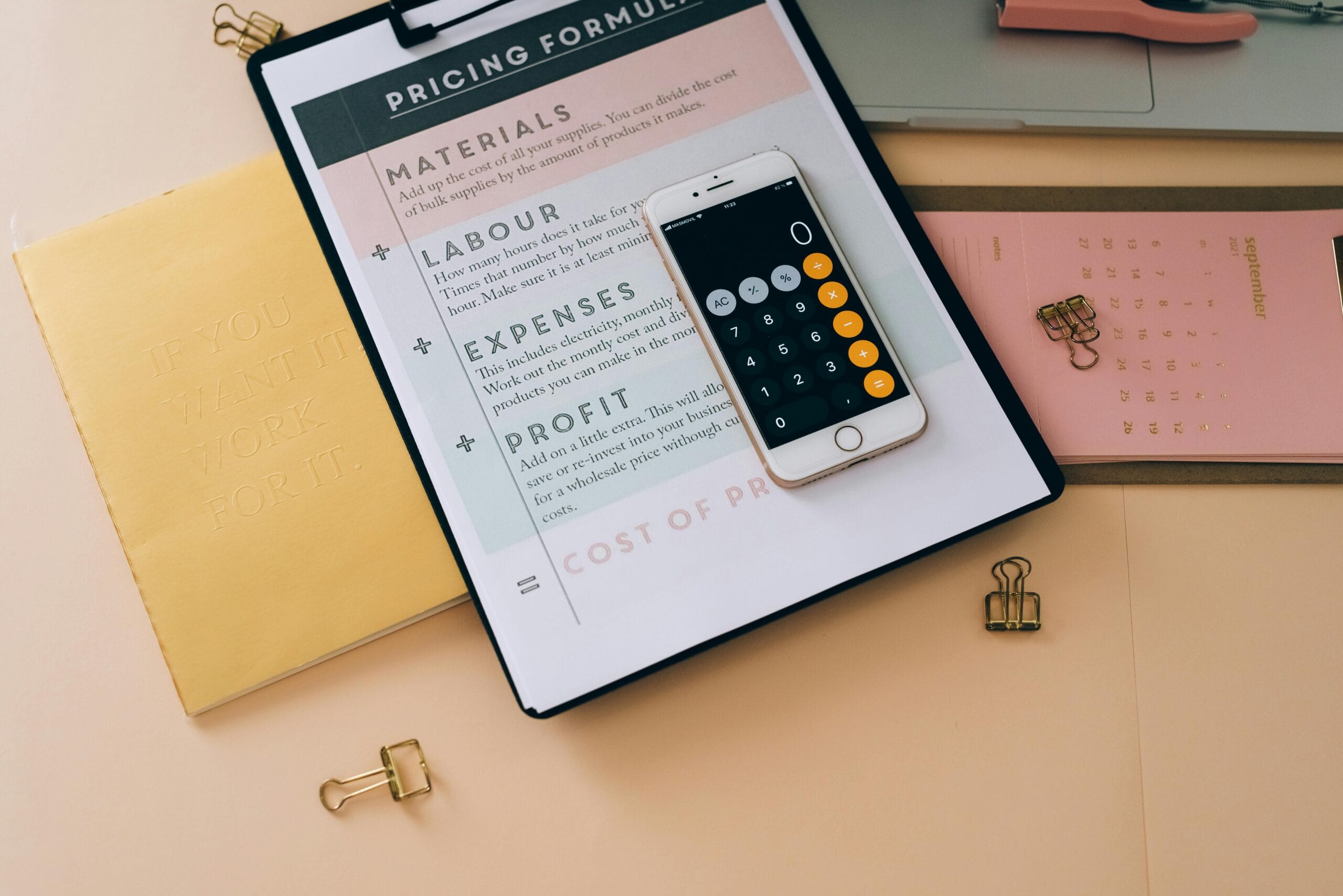 a clipboard with a pricing formula worksheet on it