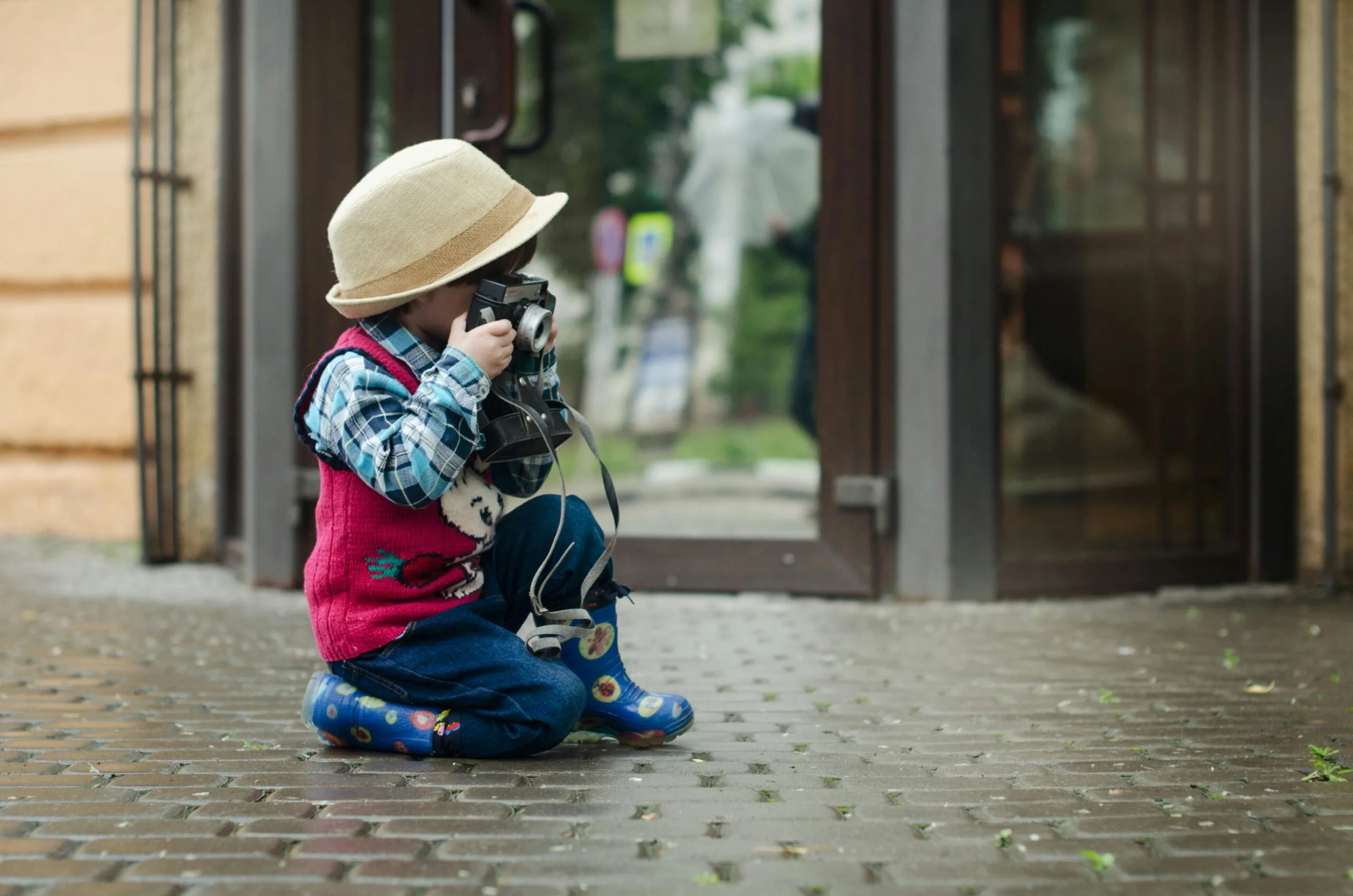 little boy taking a photo with a camera