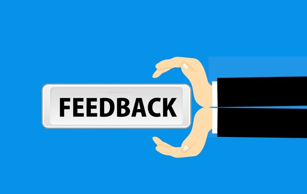 hands holding a sign that says 'feedback'